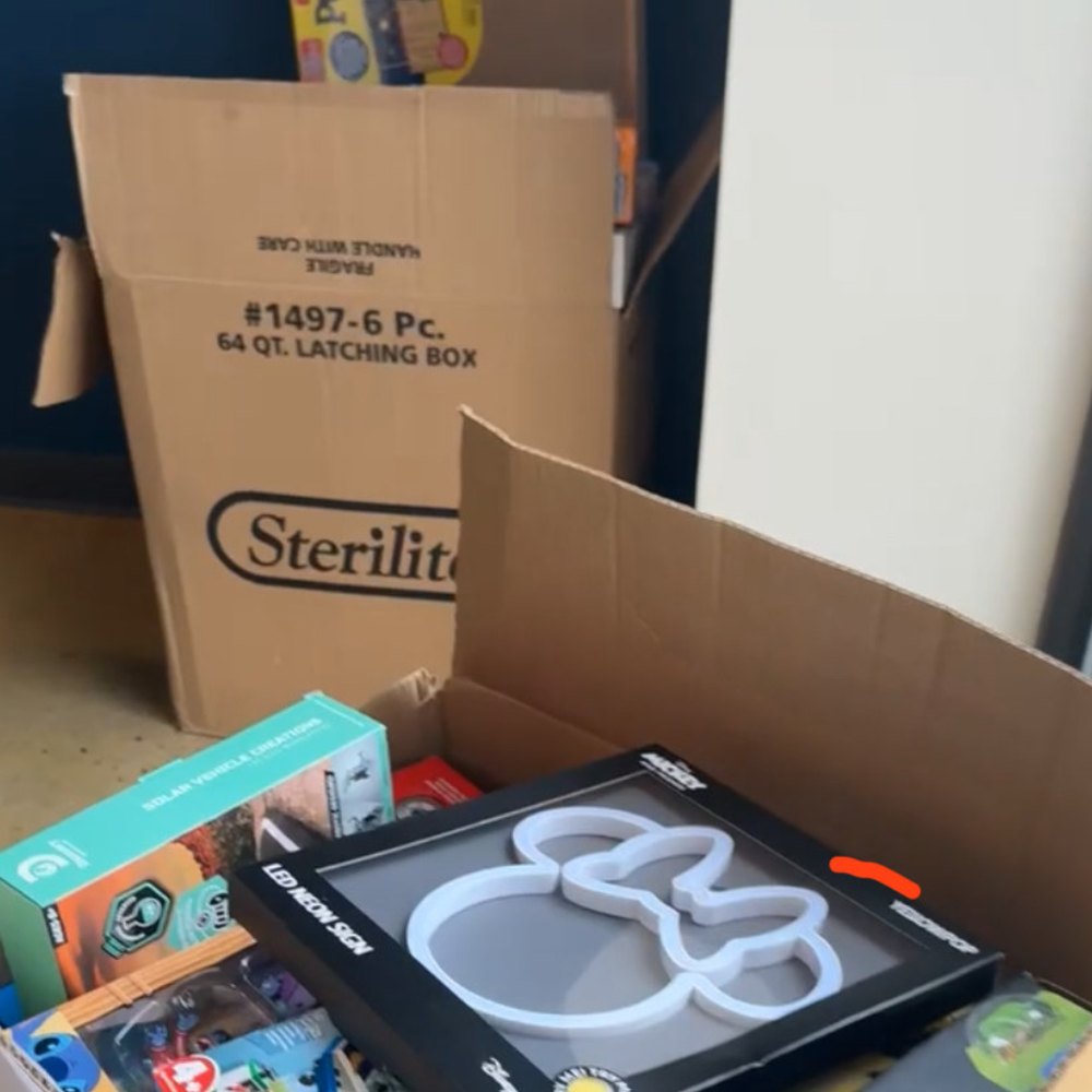 Donated STEM toys being sorted and packed into boxes for delivery to families.